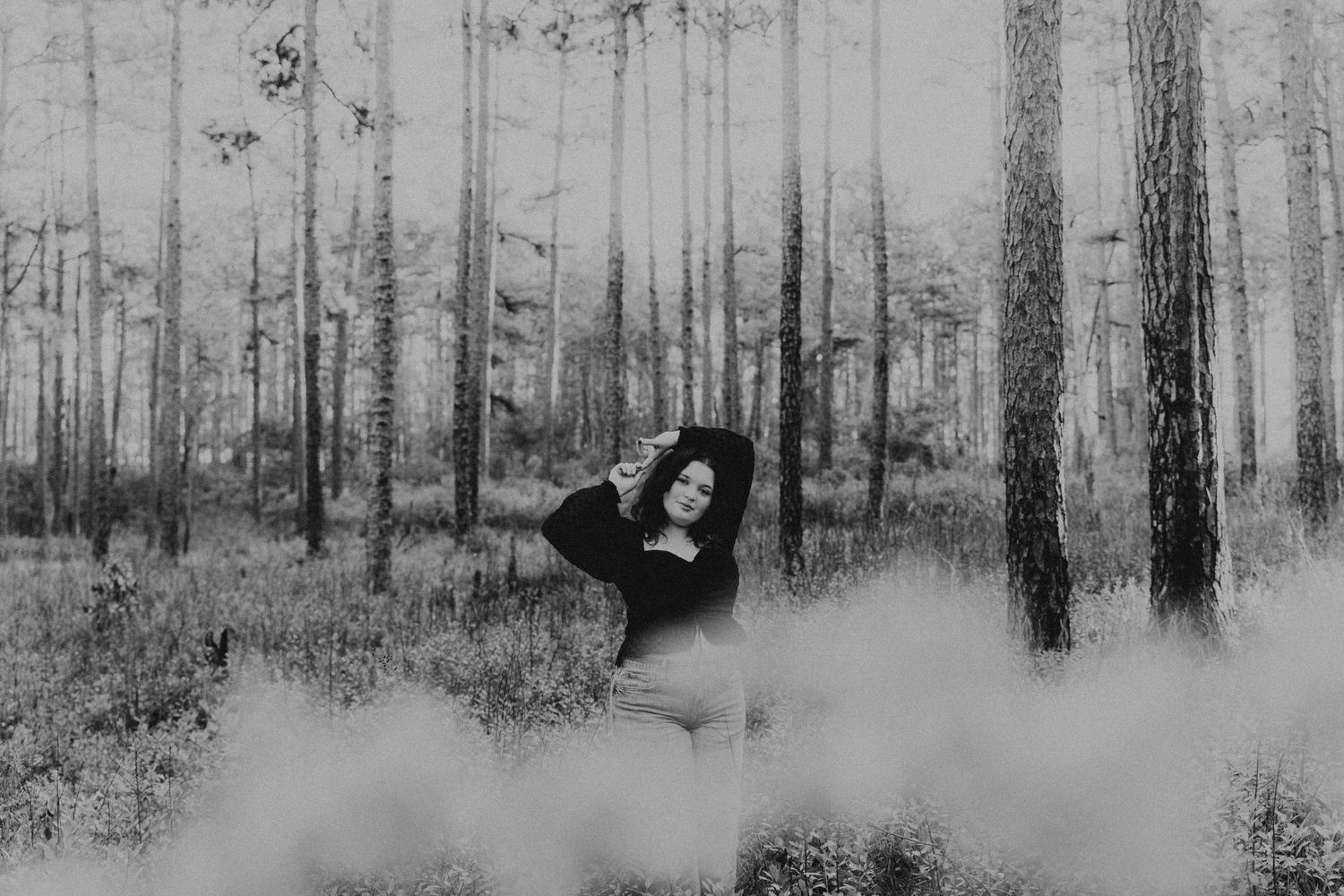 girl posing in the woods for senior pictures