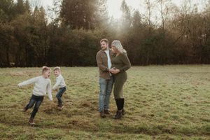 Candid family photos of parents and children running through a grassy field at sunset.