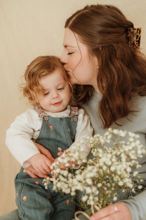 Close-up shots of tender moments with baby's breath flowers in foreground.
