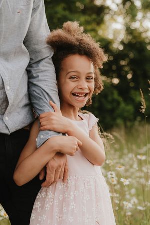 Joyful candid moments captured in a summer meadow with natural sunlight.