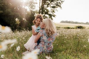 Candid family interactions during golden hour in a wildflower field.