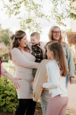 A joyful family shares candid moments together outdoors in a series of connected photos showing natural interactions.