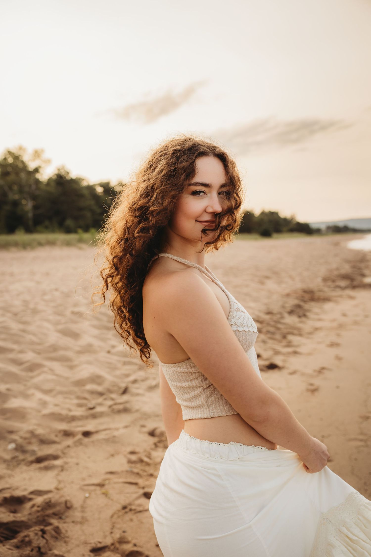 High school senior holding a microphone on a stage with the light behind her in Duluth Minnesota photographer
