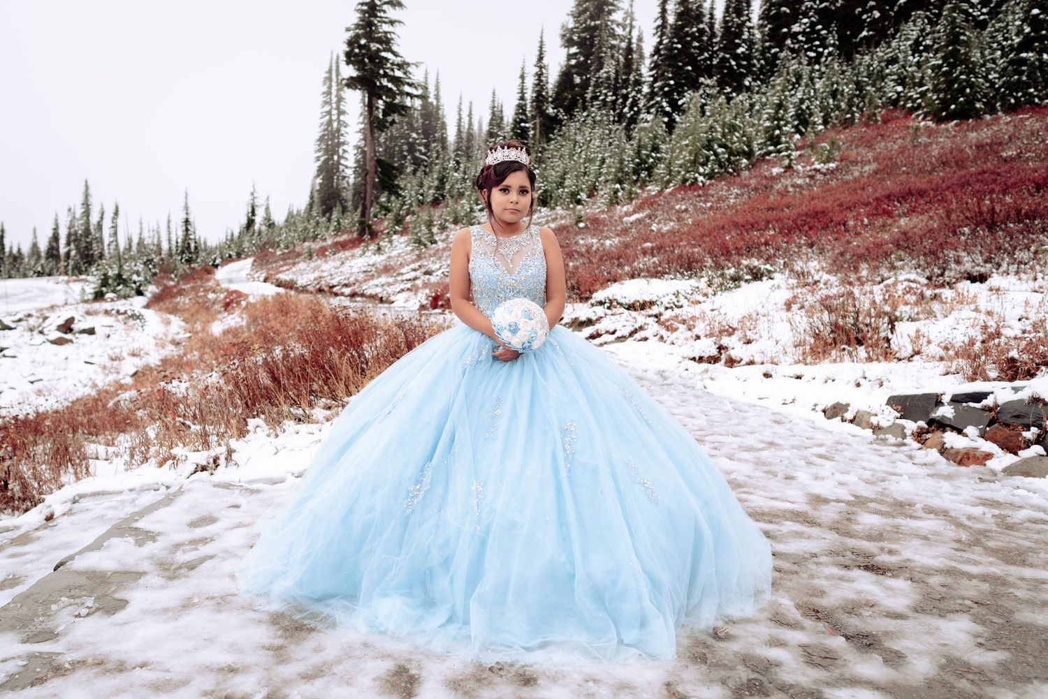Quinceañera-style gown in snowy Mt Rainier landscape, winter editorial portrait in PNW forest.