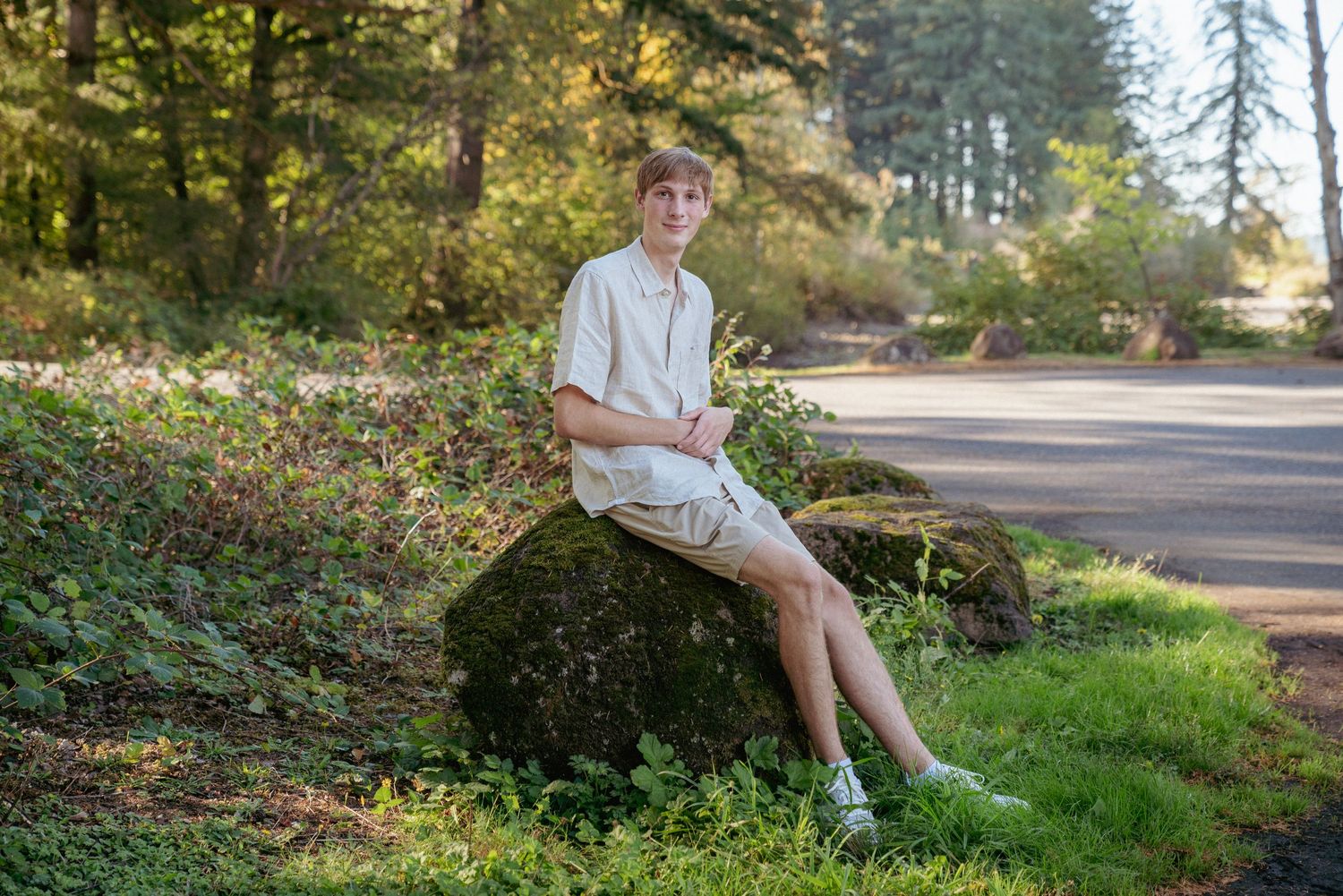 Peaceful senior photo in wooded Portland park, Pacific Northwest greenery in soft afternoon light.