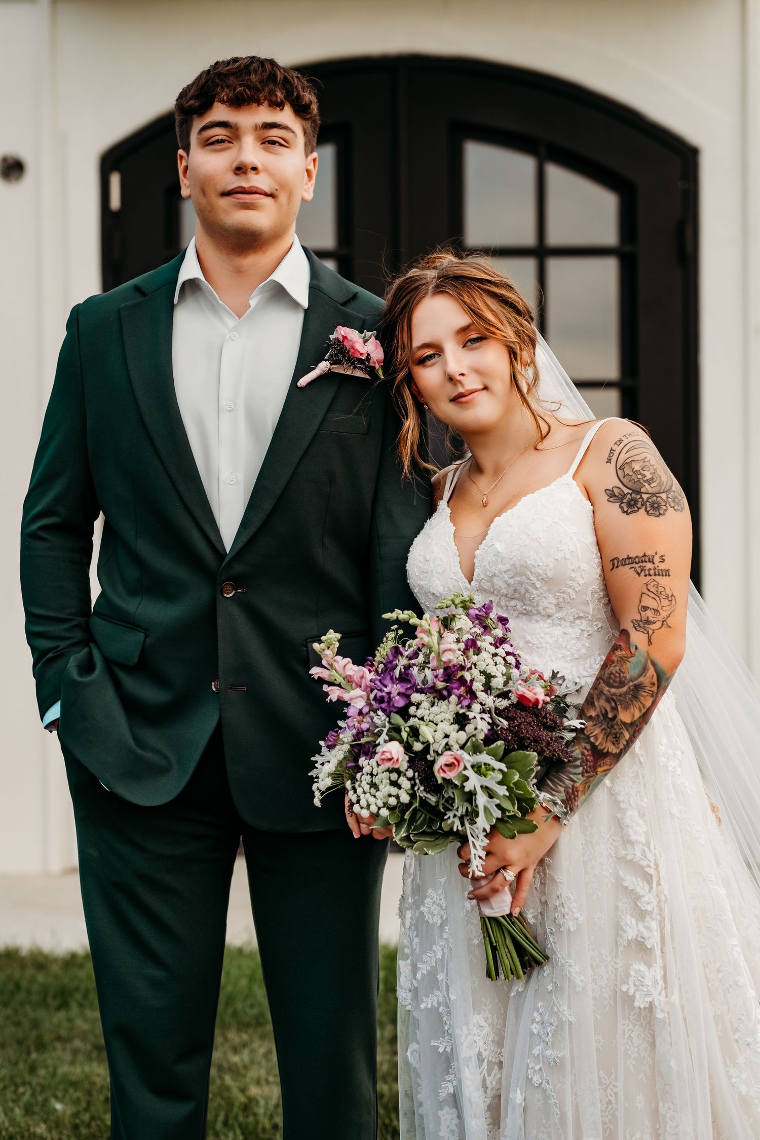 Couple stands next to chapel in wedding attire in Pea Ridge, Arkansas.