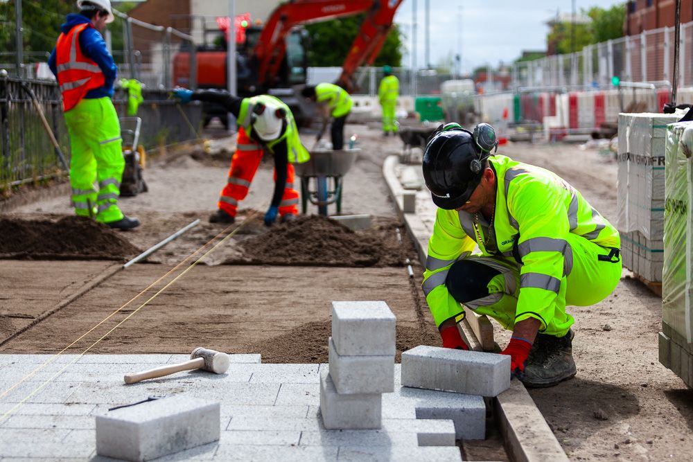 Construction photograph of man laying blocks