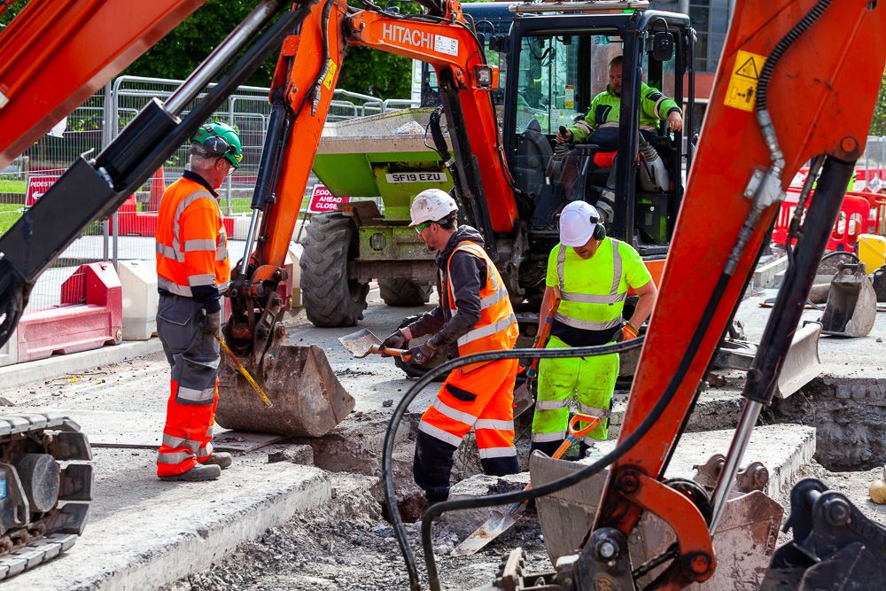 Construction photograph of workers building a pathway