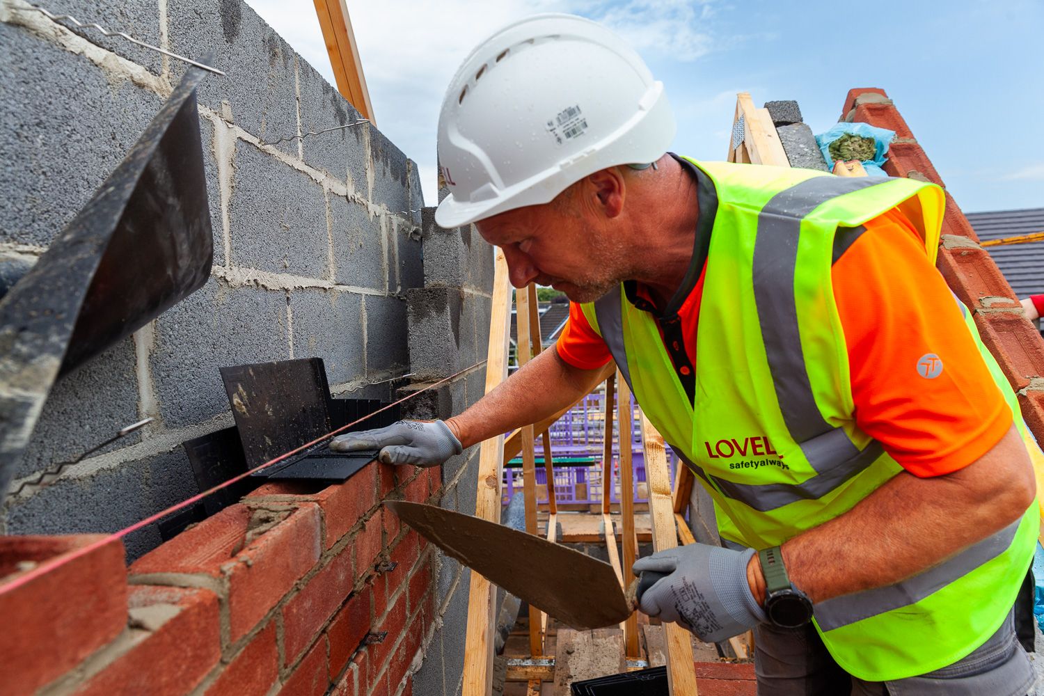 Construction photograph of House builder bricklaying