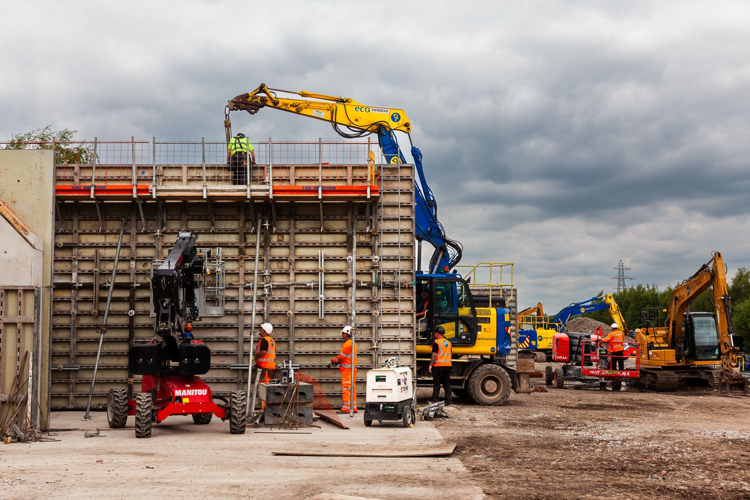 Construction photograph of concrete pouring into formers