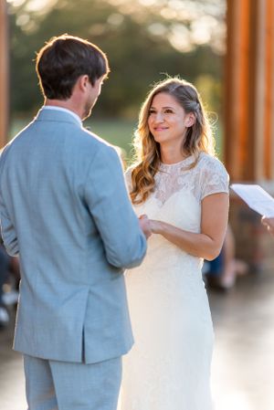 Couple exchanges vows during golden hour wedding ceremony.