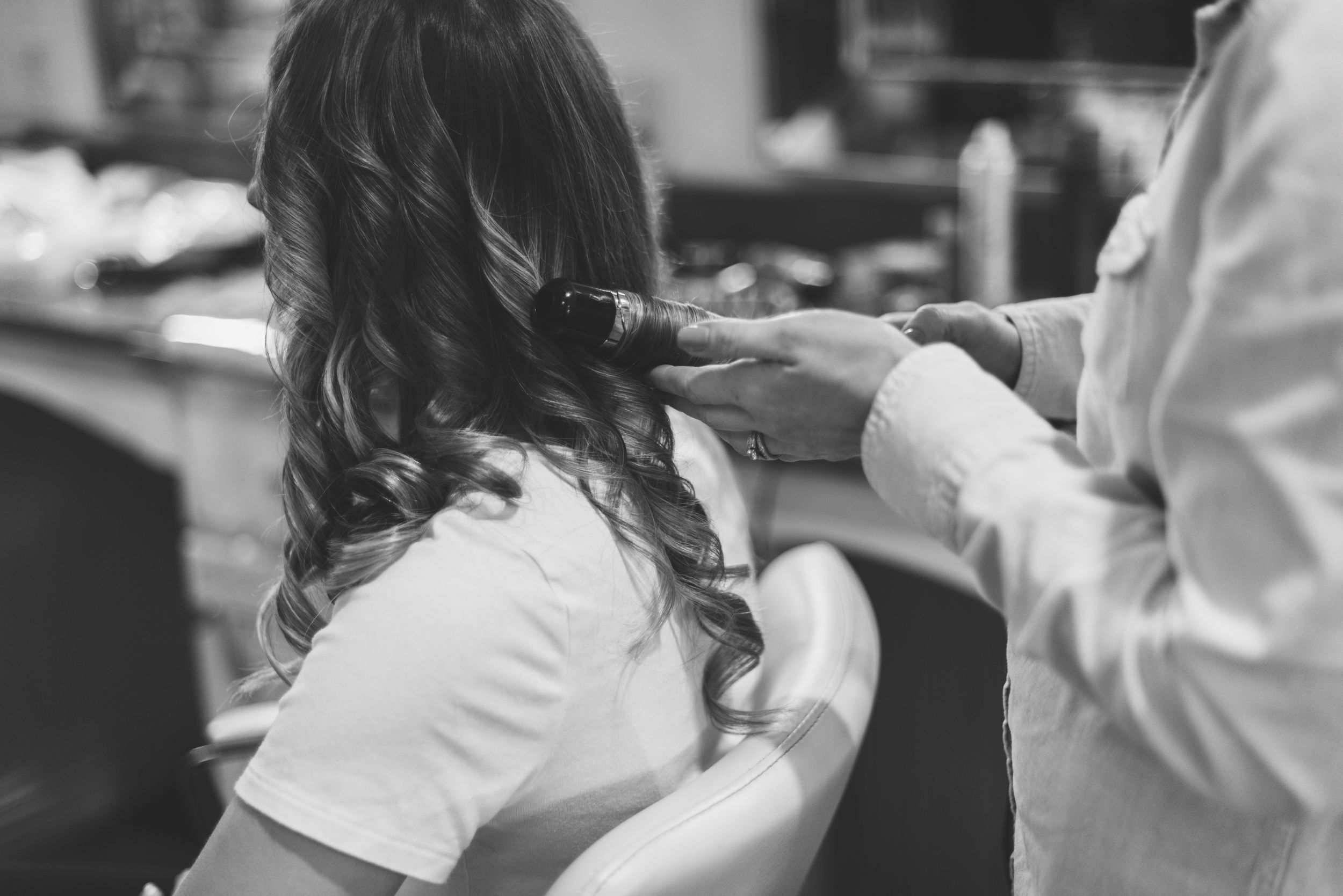 Black and white image of styling hair for a special event.