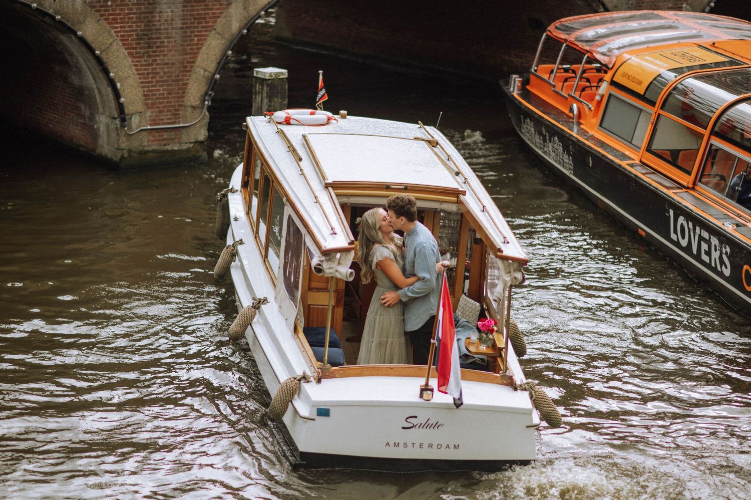 The couple on the boat after the proposal, celebrating their engagement.