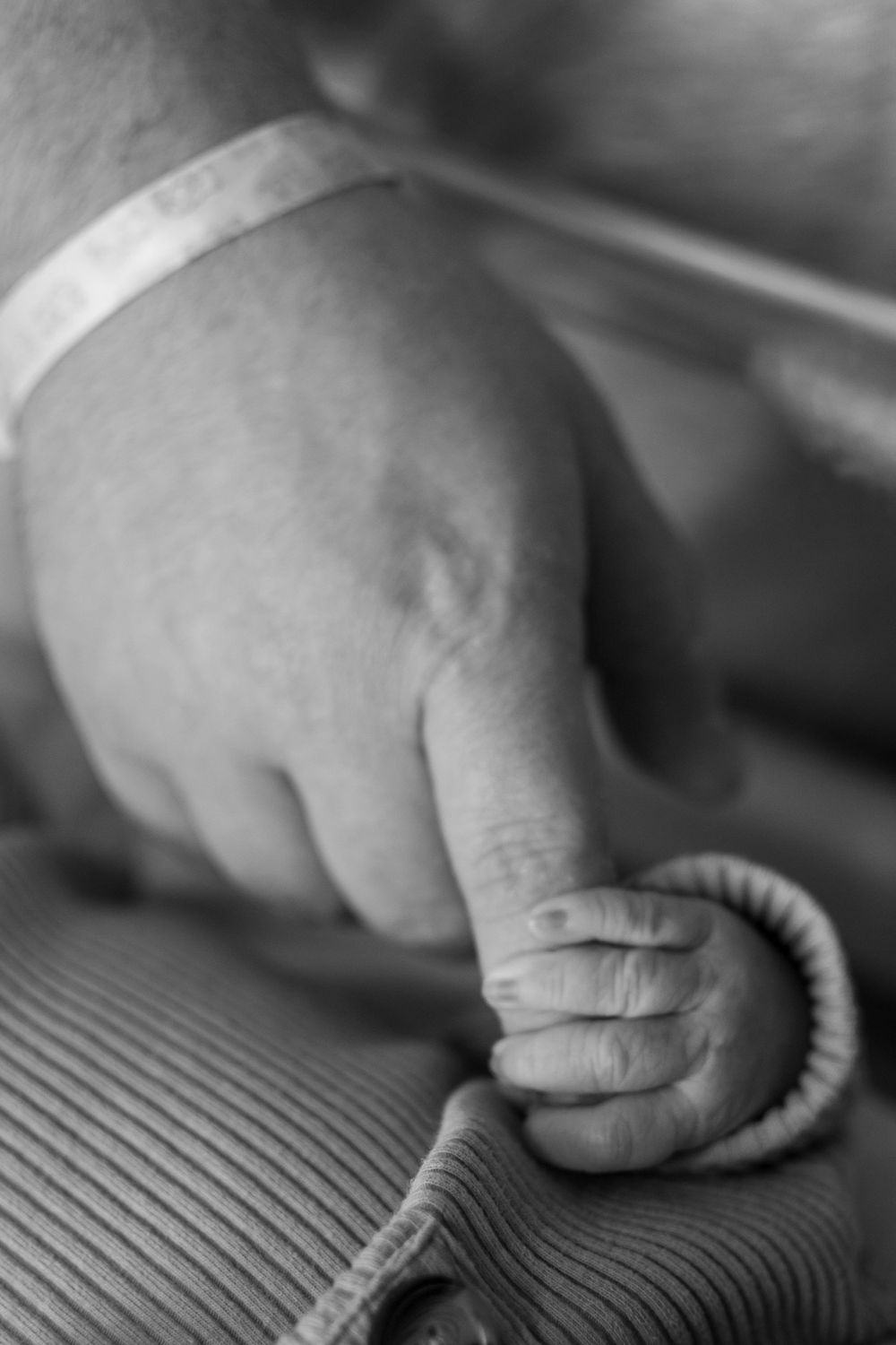 Black and white photo sequence showing hands kneading and folding dough in a rhythmic motion against a textured surface.