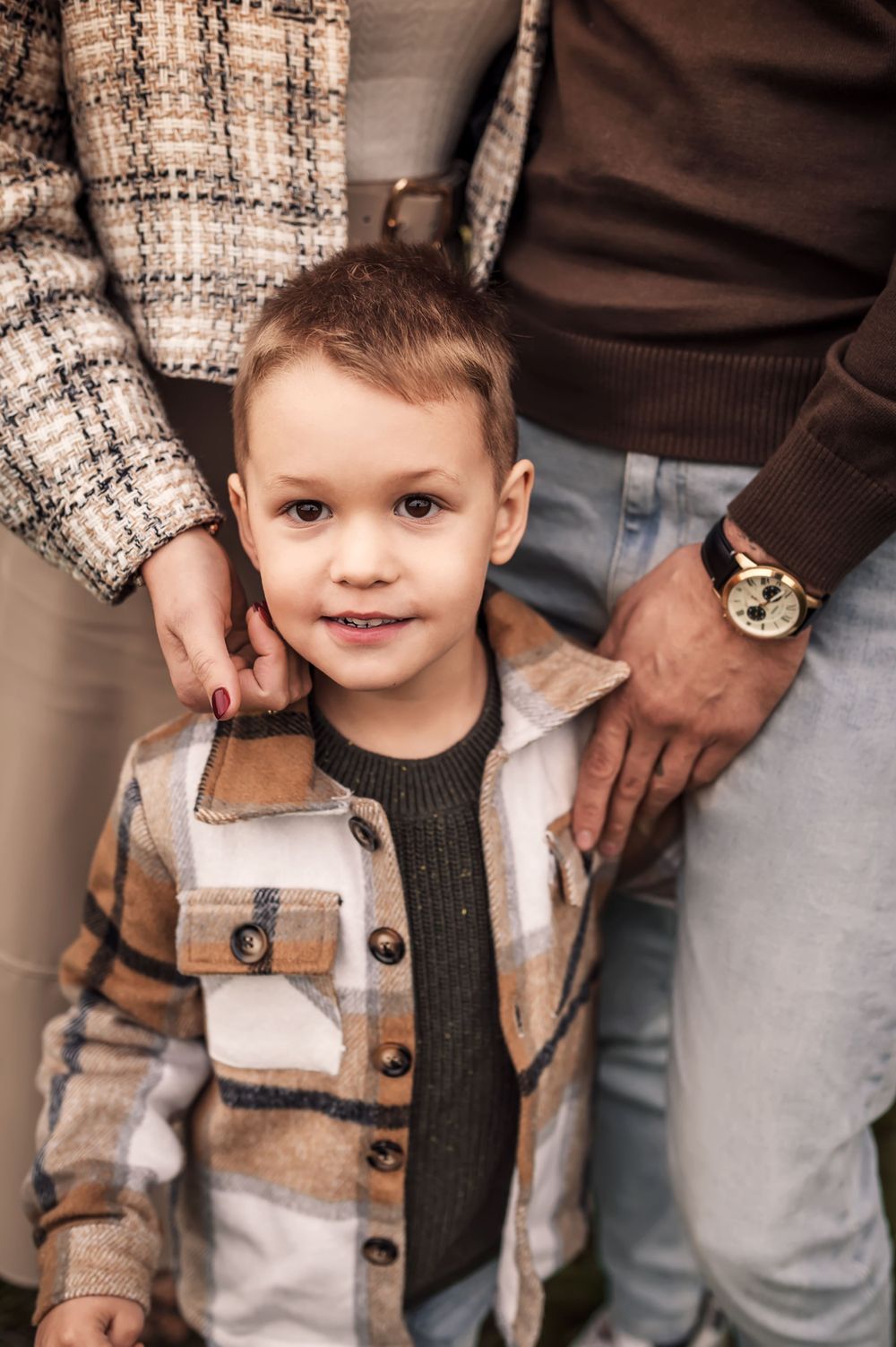 A heartwarming portrait showcasing cozy autumn fashion with plaid and knitwear textures.