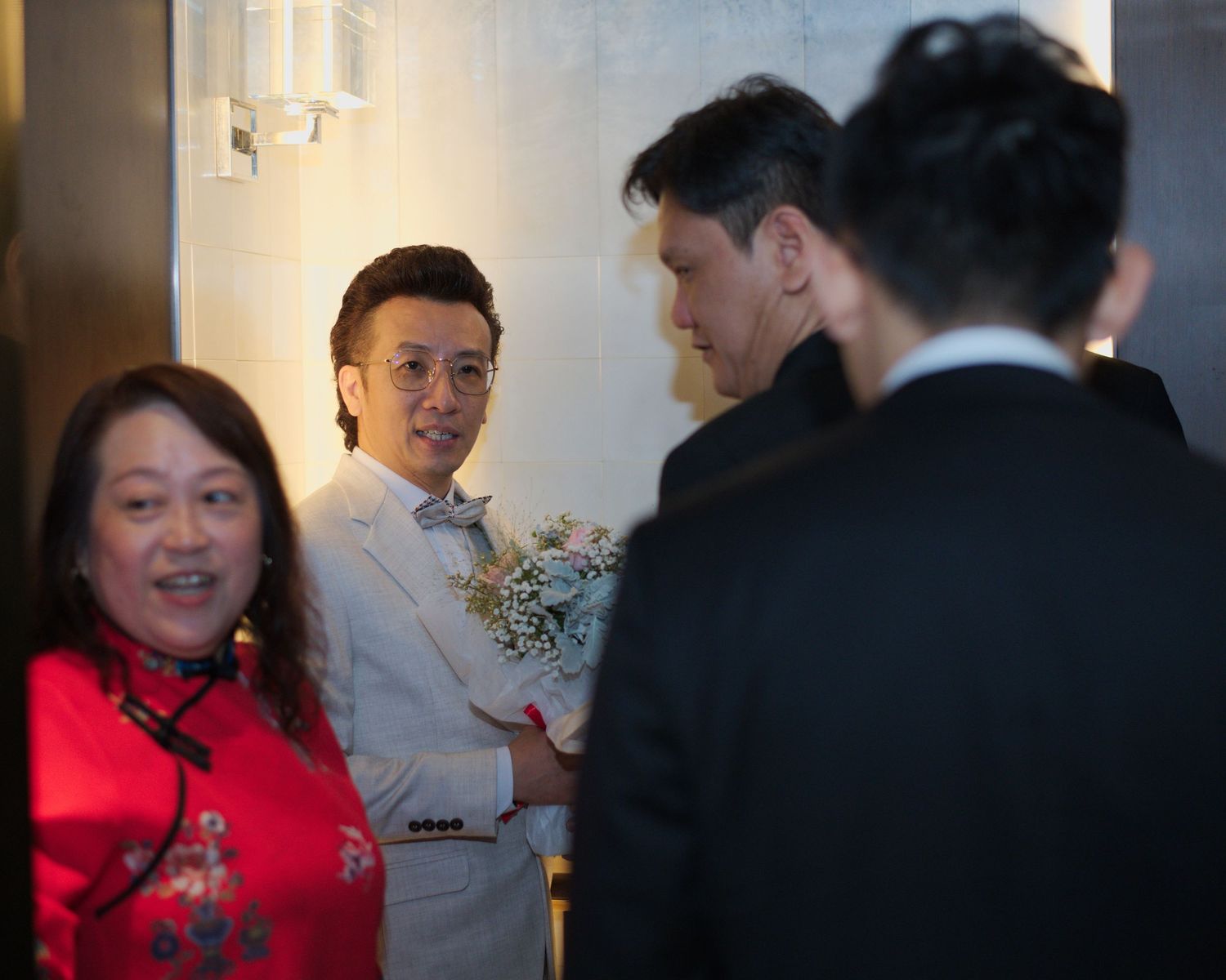 Guests in formal attire gather during a wedding celebration.