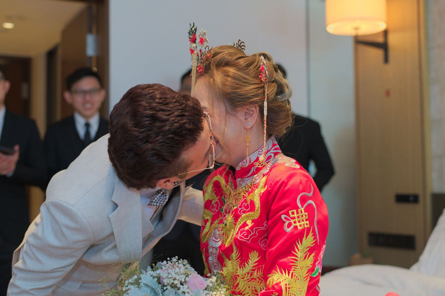 A tender moment between newlyweds during a traditional Chinese wedding ceremony.