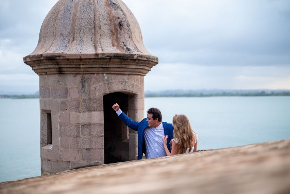A playful moment exploring a historic stone watchtower with ocean views.