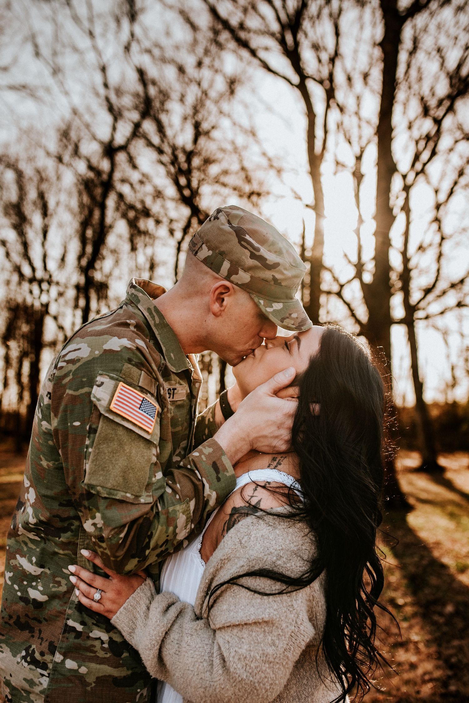 Military Deployment session of a solider kissing his wife at Fort Campbell, Tennessee.