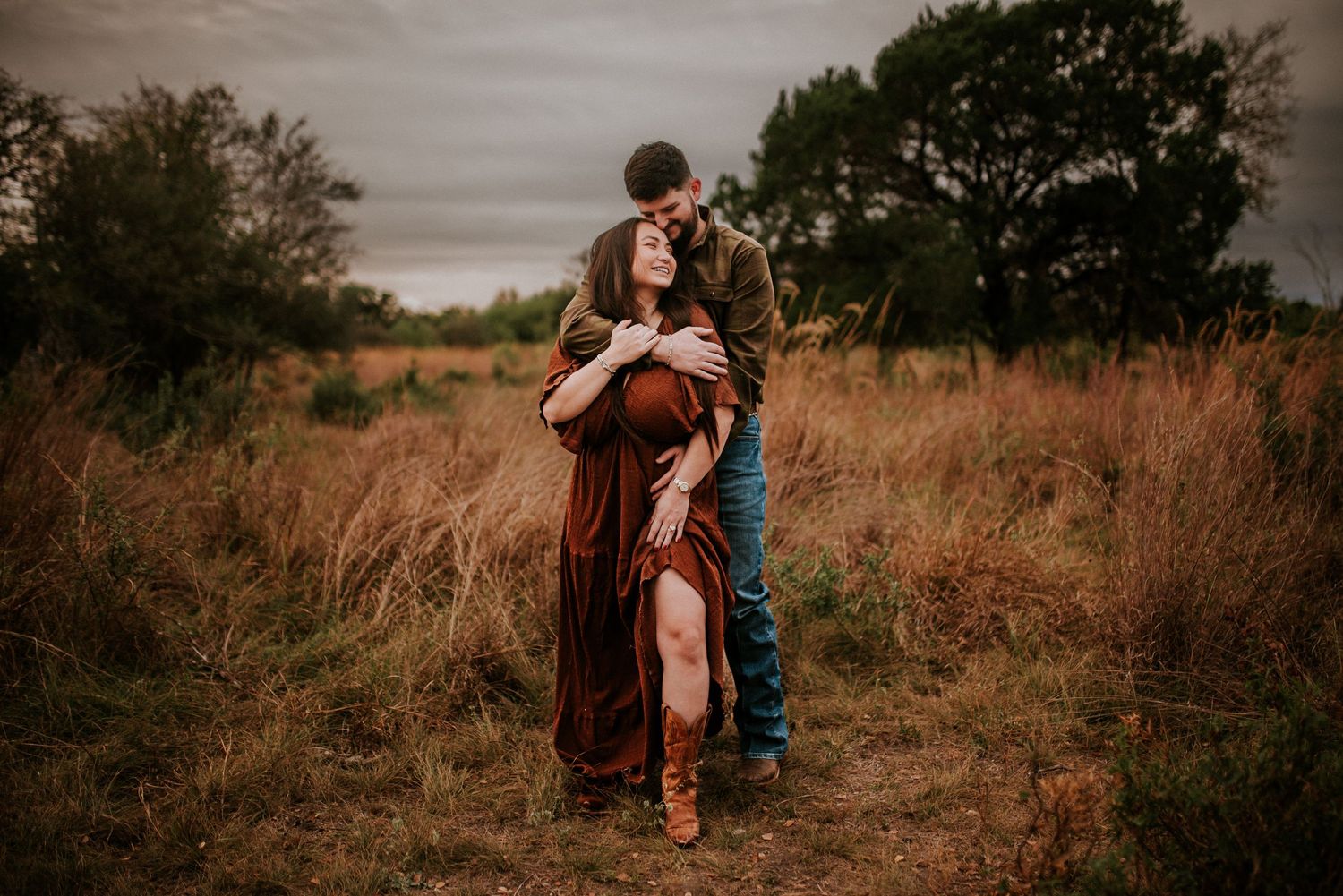 A Couple embracing in a field during winter in San Antonio, Texas.
