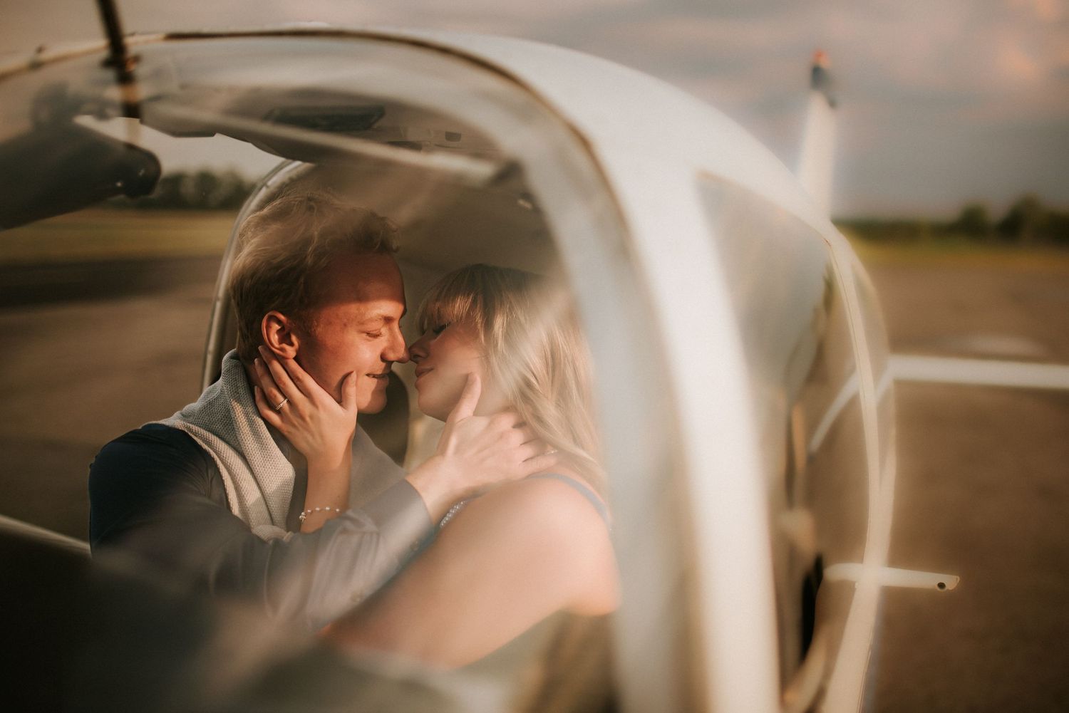 A couple cuddling with each other in a personal airplane in Tennessee.