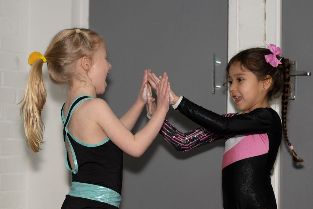 Gymnasts performing various poses and movements during practice in a gym setting.