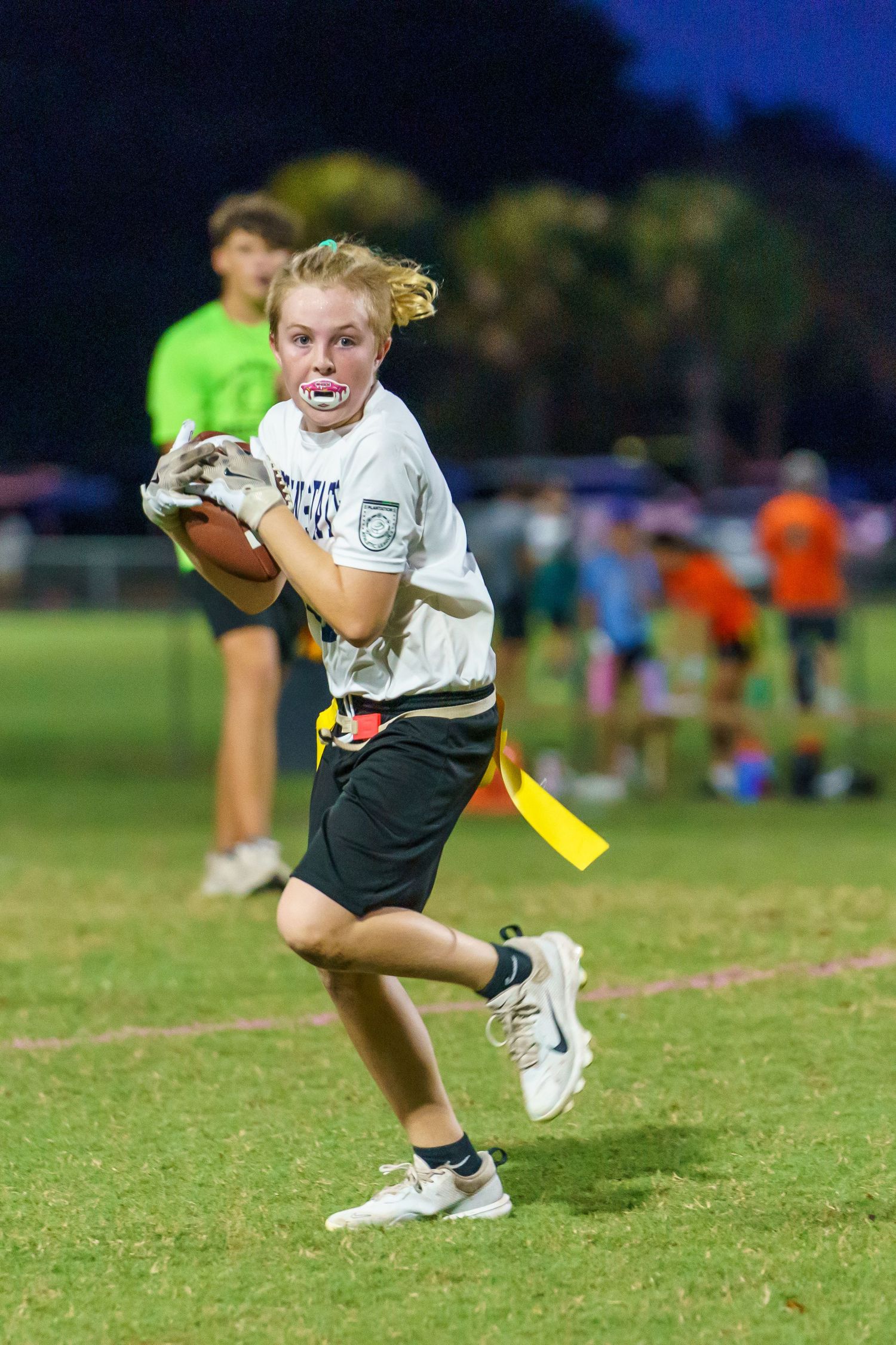 Young kids football player running with ball during youth game, action-packed sports photography by SRX Media Group