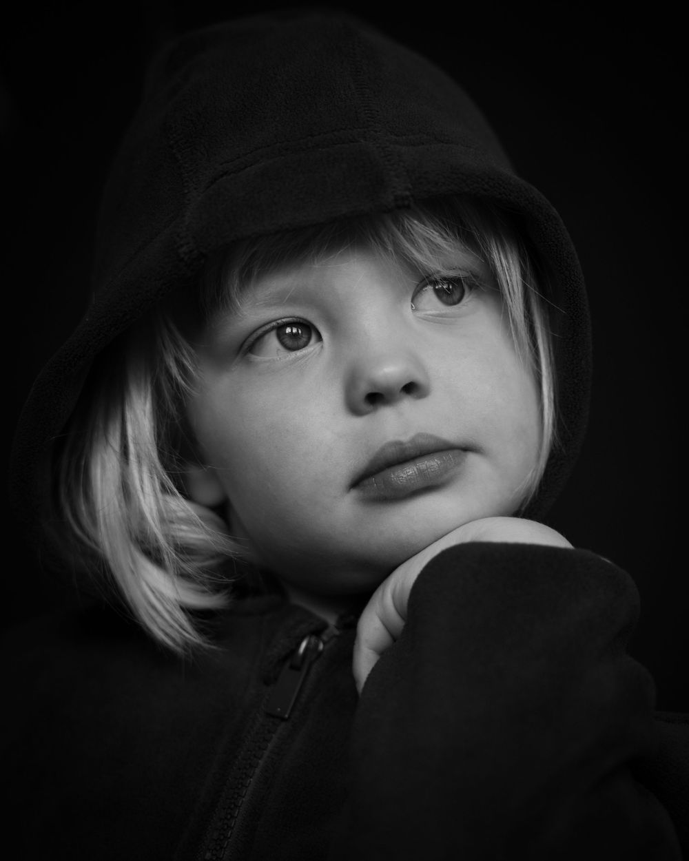 Dramatic black and white portrait series showing different angles and expressions in shadow and light.