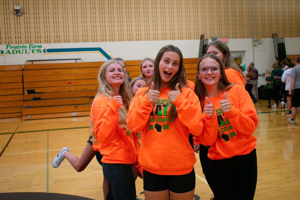 Members of the Prairie Farm Wisconsin Cross Country team 2024 giving a thumbs up to the camera.