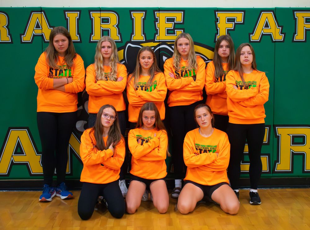 Prairie Farm Wisconsin Cross Country team 2024 standing posed with serious faces.