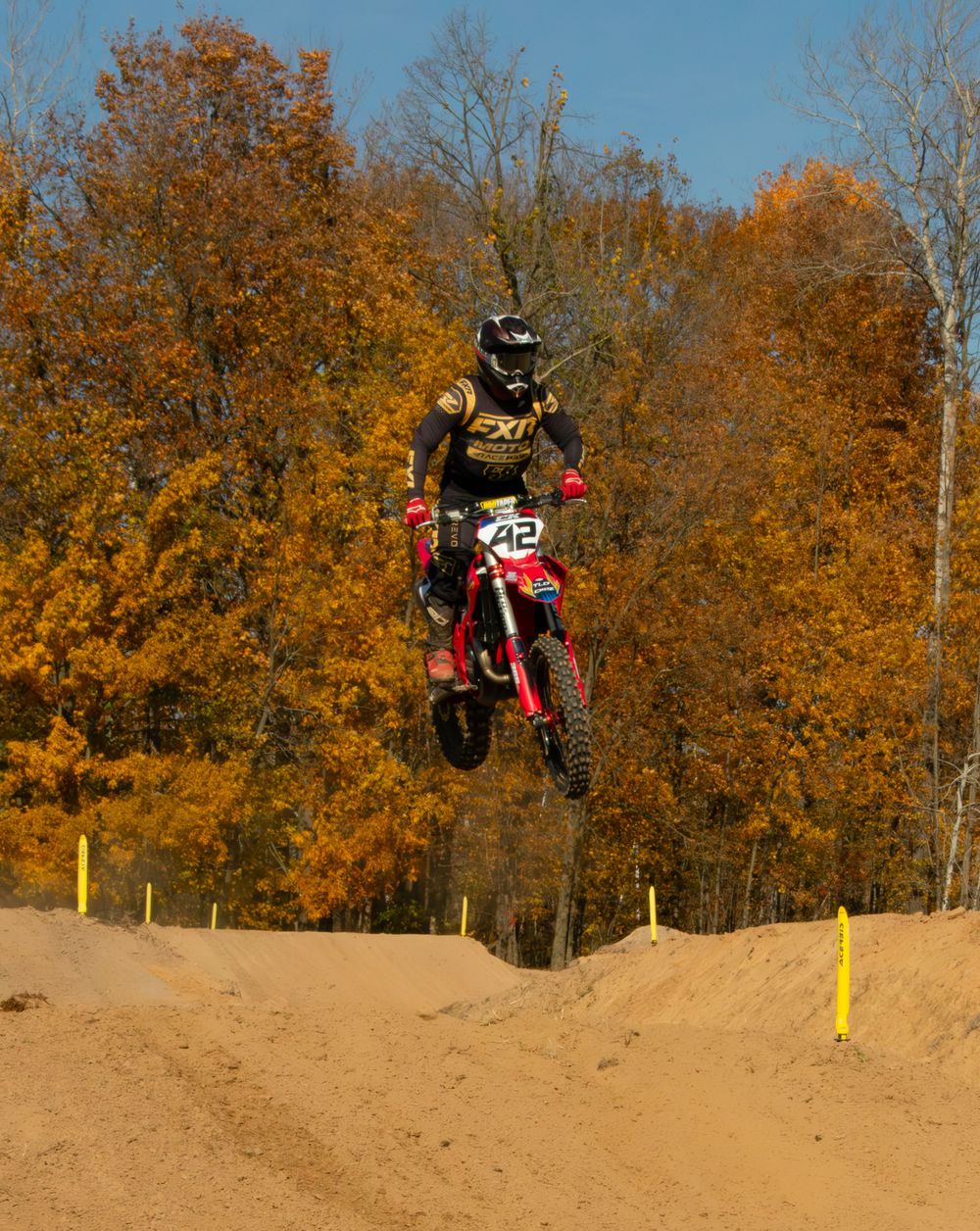 Motocross rider jumping a jump.
