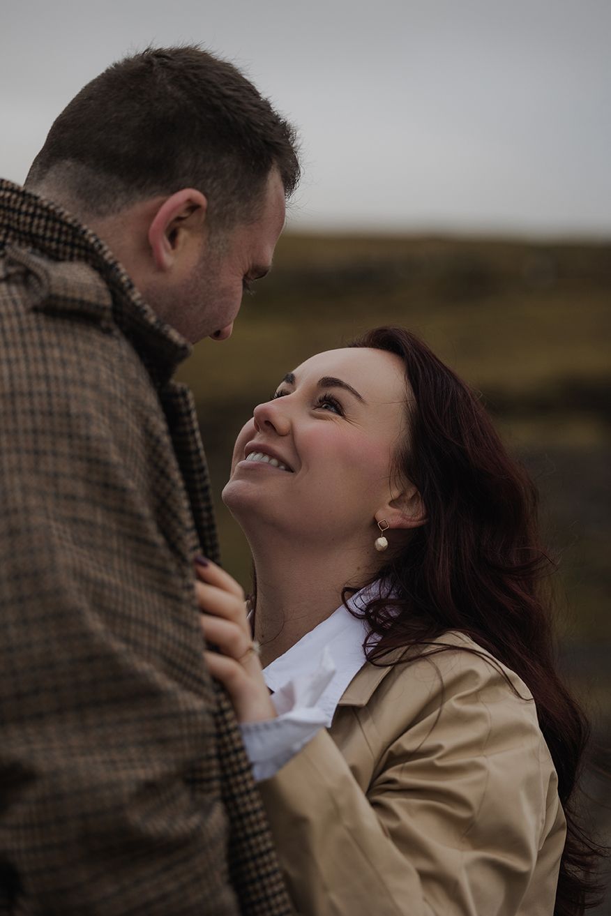 Couple sharing intimate moment during dramatic sunset engagement session on Doolin Cliff Walk