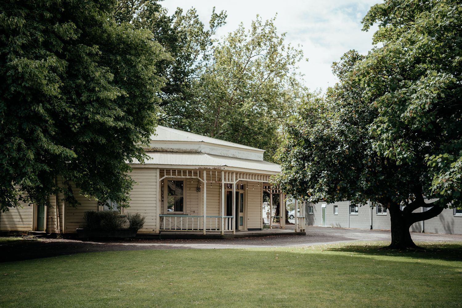 The Round Bar at Rose & Smith nestled among lush green trees on a sunny day captured by August and Vine