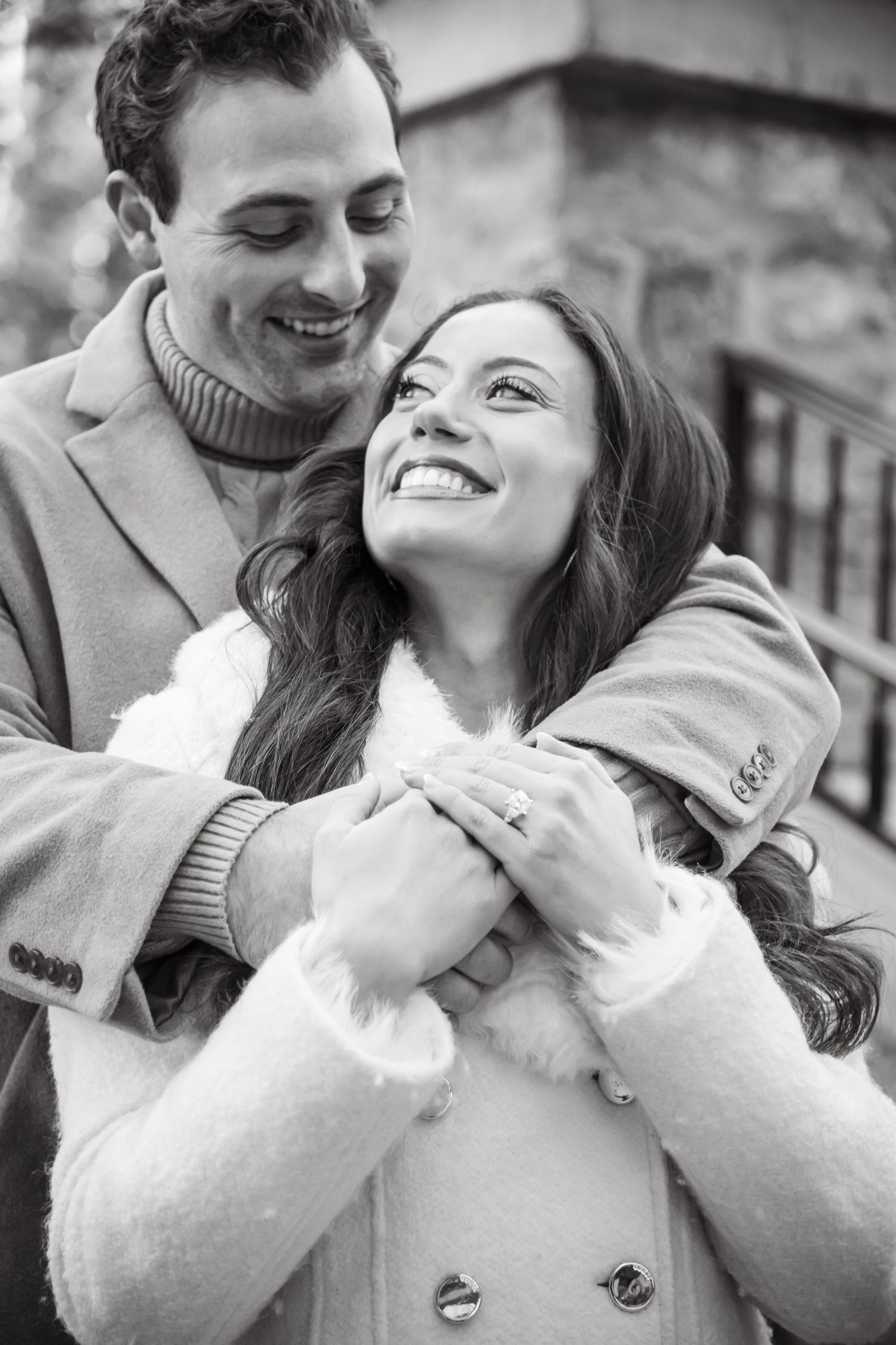 A couple shares tender moments together in a black and white photo during a cute winter engagement photo session in Vail Colorado