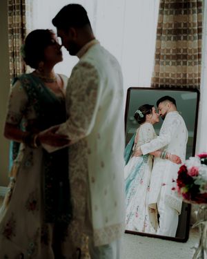 A couple shares an intimate moment in a series of wedding portraits with a moody, dark aesthetic.