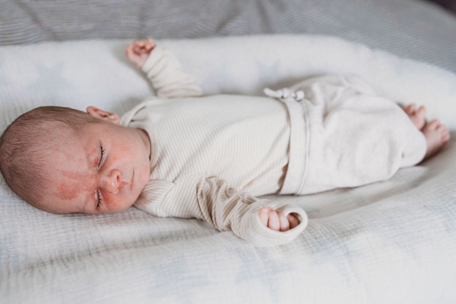A series of peaceful images showing a sleeping newborn baby in white clothing on soft white bedding.