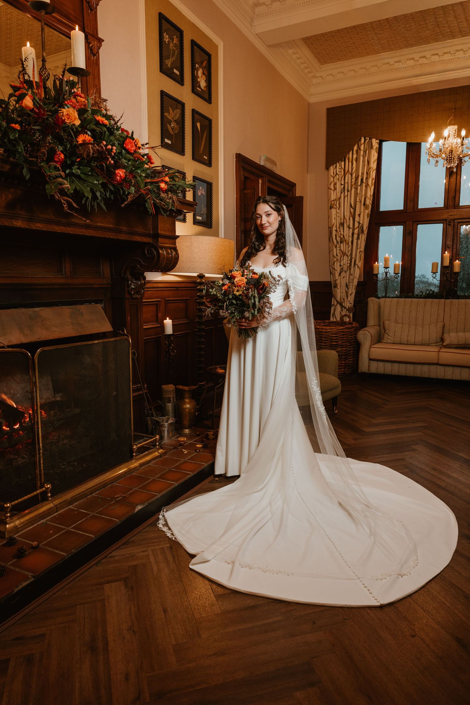 A flowing white wedding dress with a dramatic cathedral-length train creates an elegant silhouette in a luxurious indoor setting.