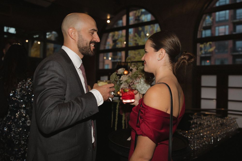 A couple in formal attire shares an intimate moment during a romantic dance at an evening event.