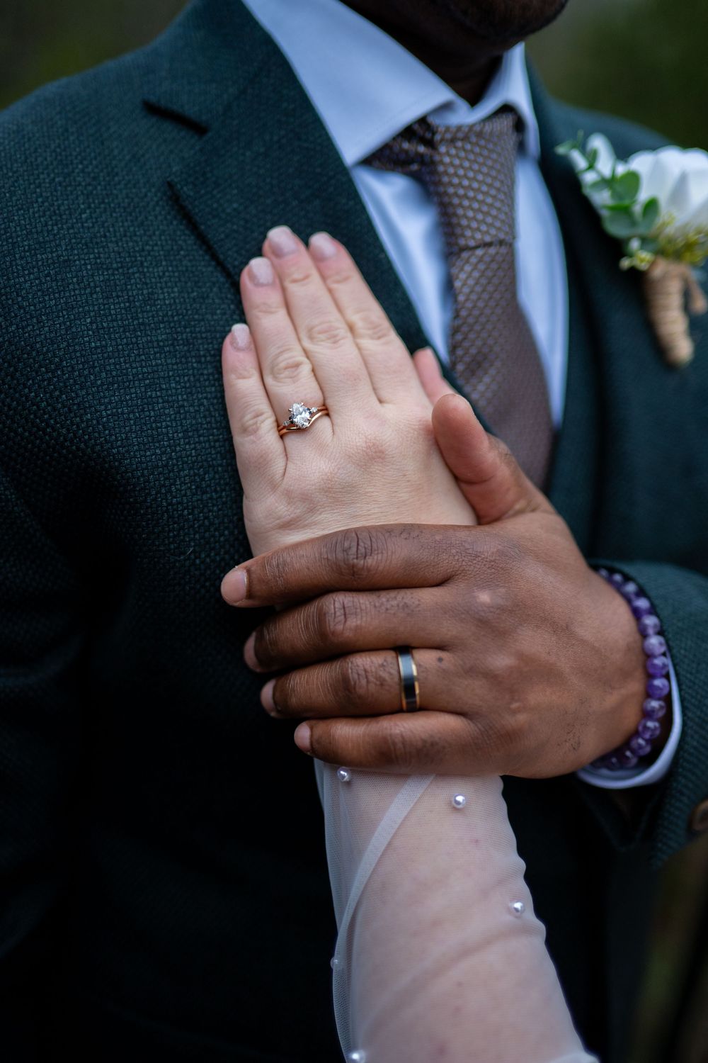 Close-up shots of wedding rings and clasped hands showing both bride and groom's wedding bands.