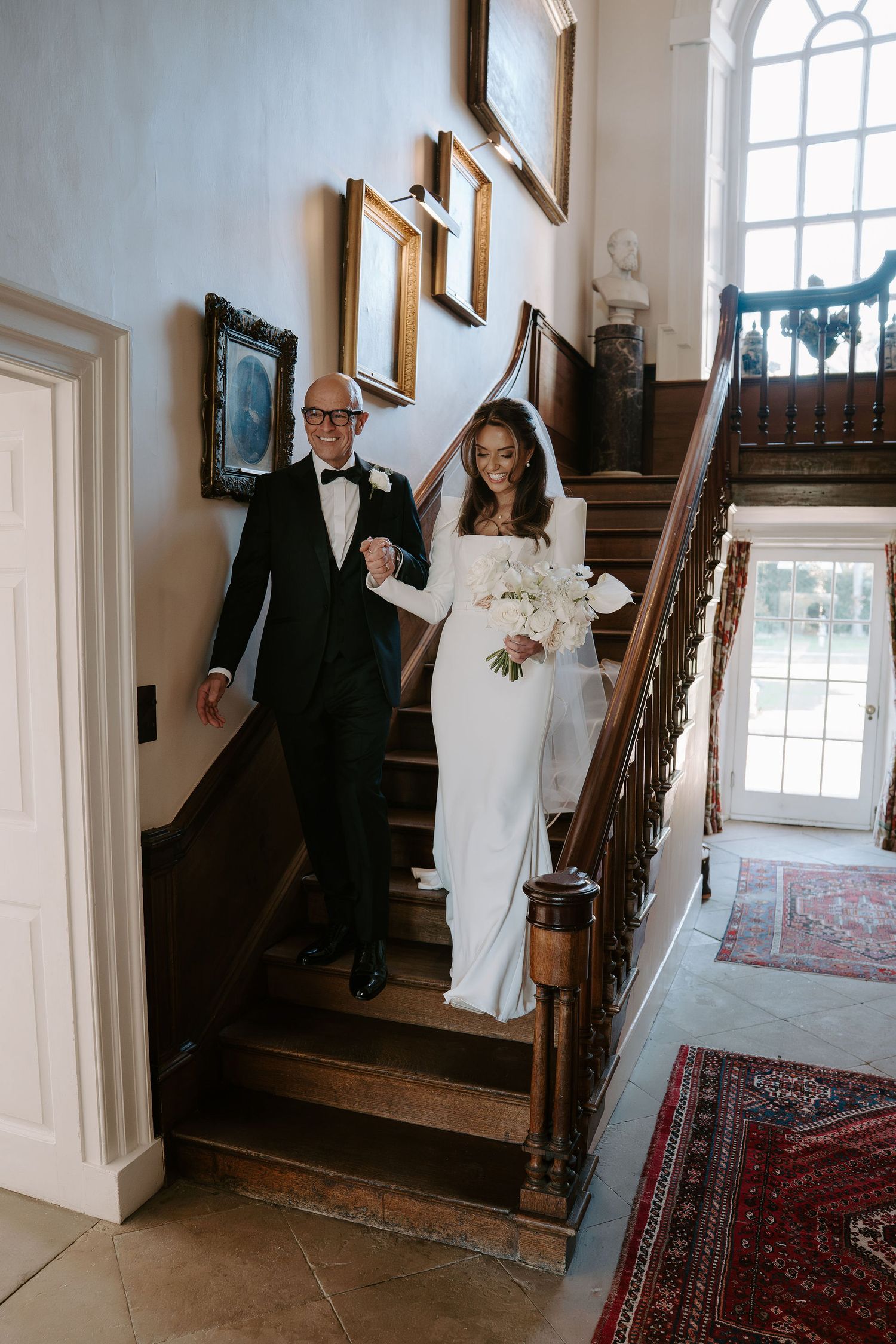 bride and dad descending stairs on their way to the ceremony at Iscoyd park