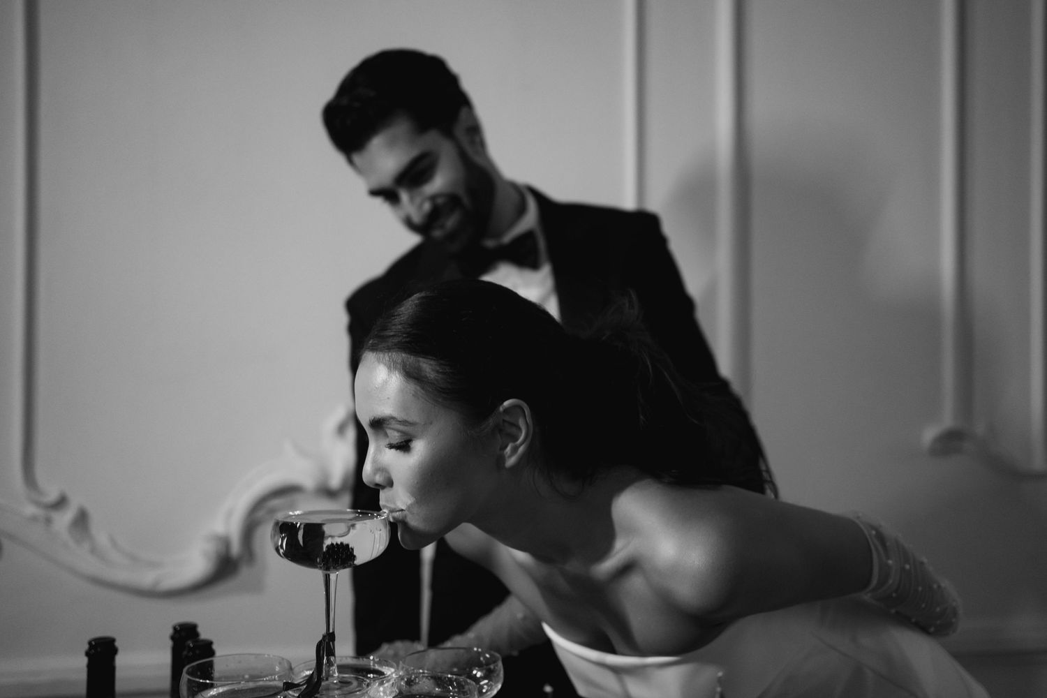 An intimate black and white moment captured during wedding preparations.