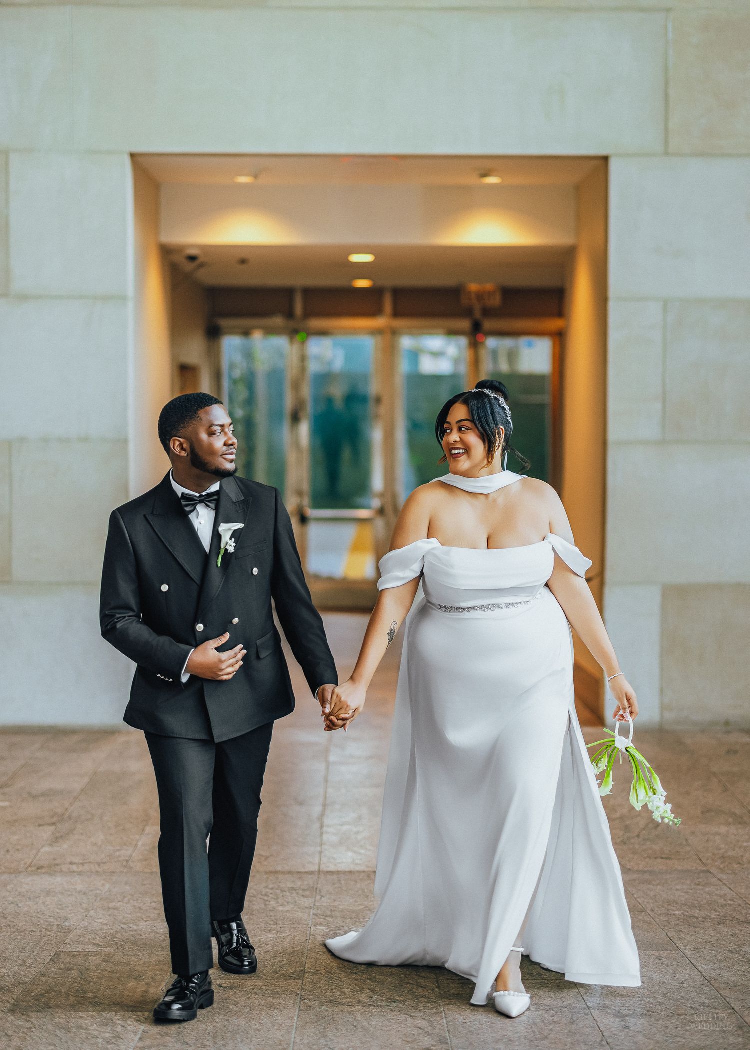 A creative wedding photo series showing a couple's feet in formal attire as they stand together in a hallway.