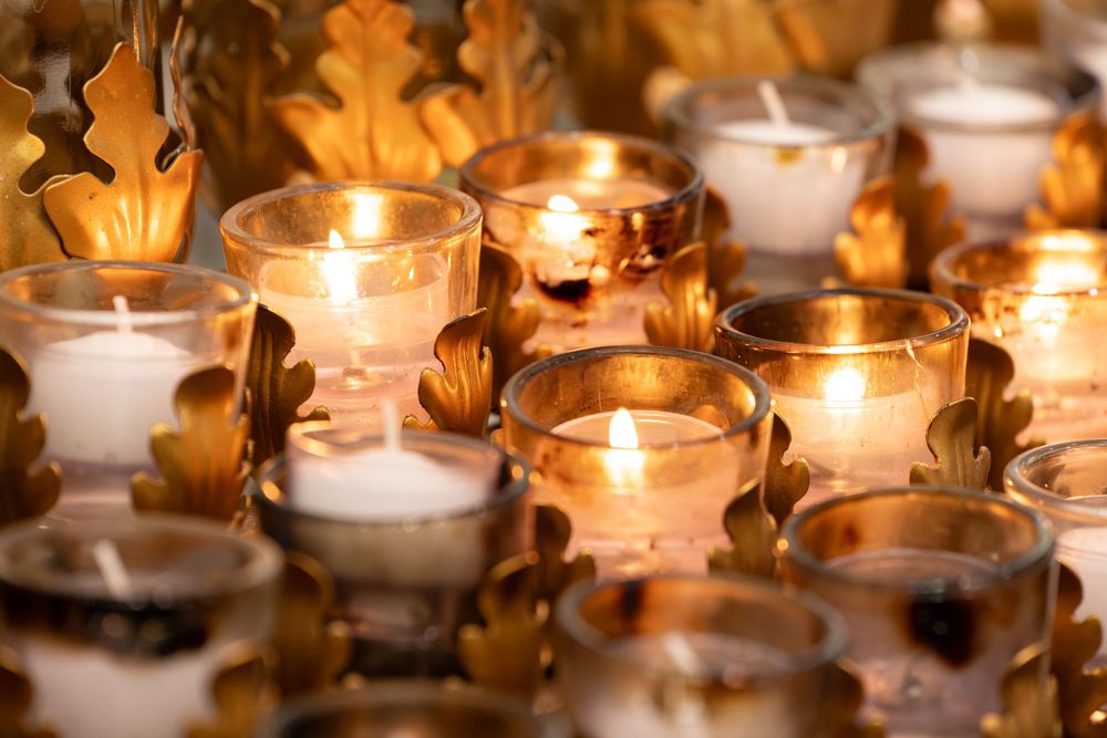 Glowing tea light candles in glass holders create a warm and peaceful ambiance.