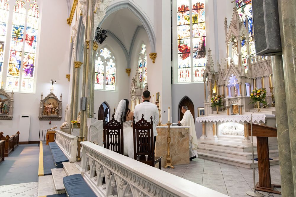 Gothic church interior featuring vaulted ceilings and stained glass windows.