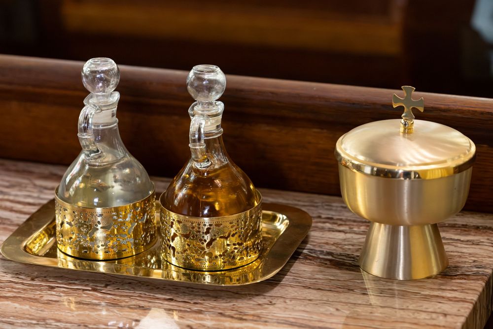 Golden religious ceremonial items displayed on wooden surface.