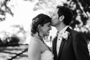 A black and white wedding photo collage showing romantic moments between the couple outdoors.