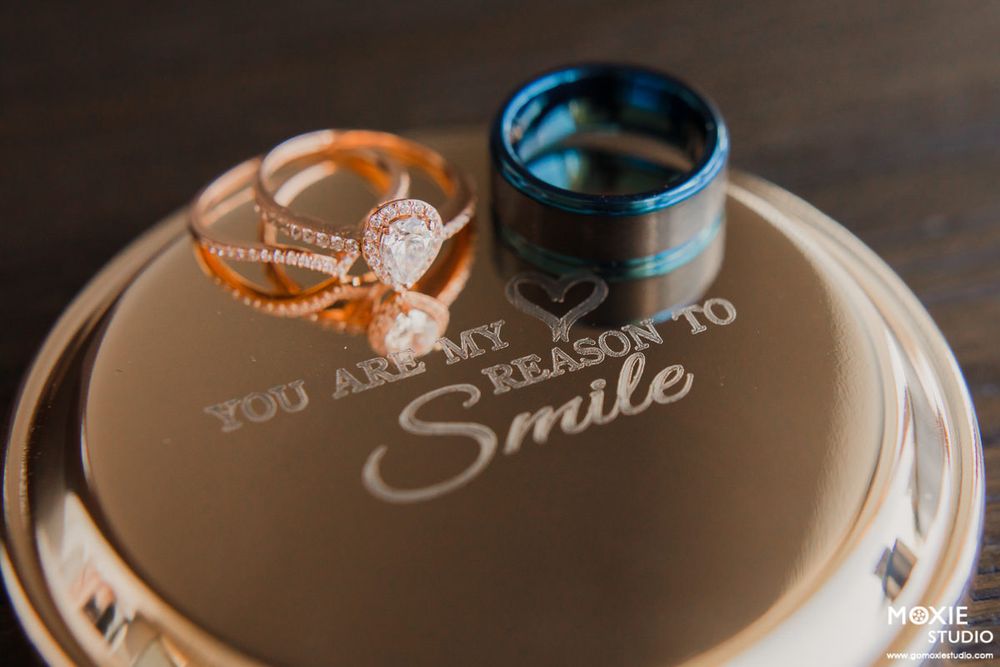 Decorative ceramic plates with inspirational text messages displayed in a row on a wooden surface.