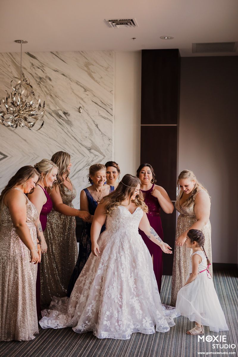 A heartwarming sequence shows bridesmaids in sparkly dresses helping adjust a bride's wedding gown before the ceremony.