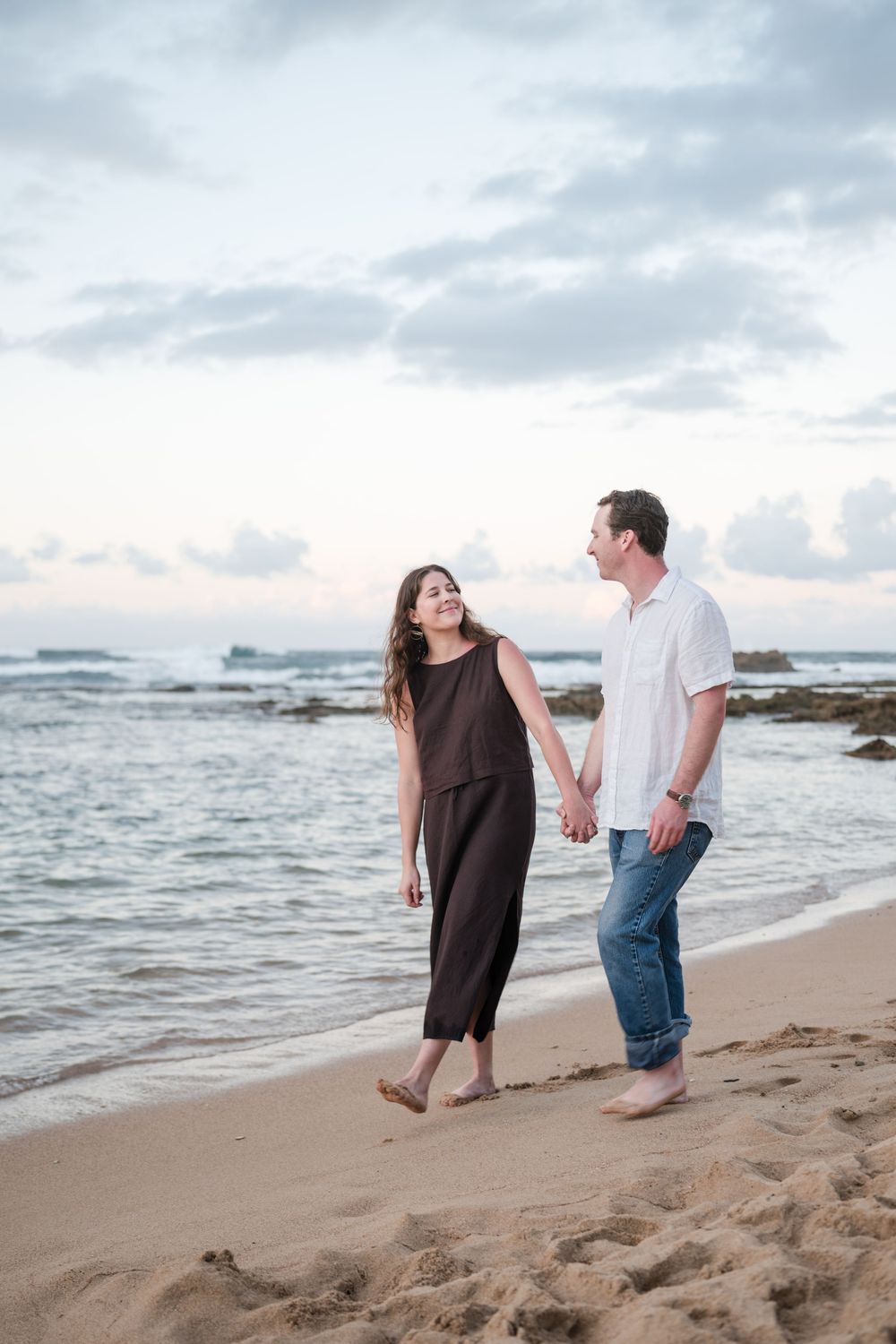 Couple posing together on rocks during engagement photos in Puerto Rico