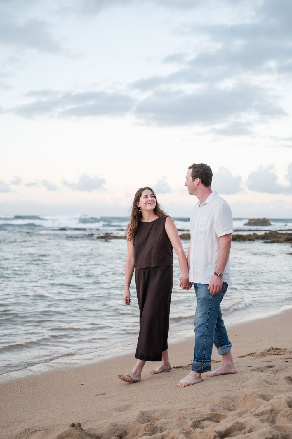 Couple posing together on rocks during engagement photos in Puerto Rico